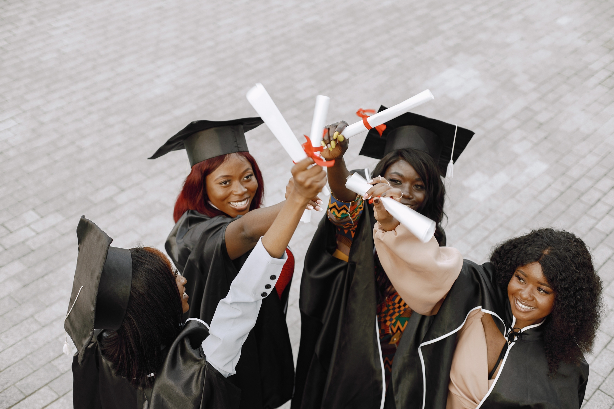 Graduates celebrating with diplomas